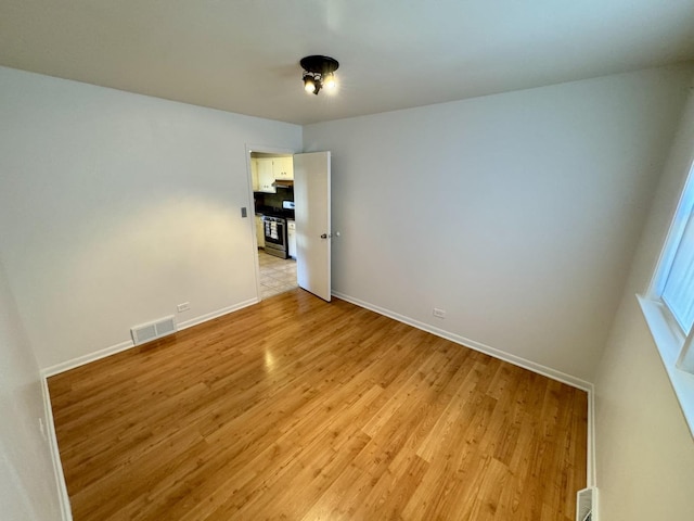 11137 S S Ave L, Chicago, IL 60617 - unfurnished room featuring light wood-style floors and baseboards
