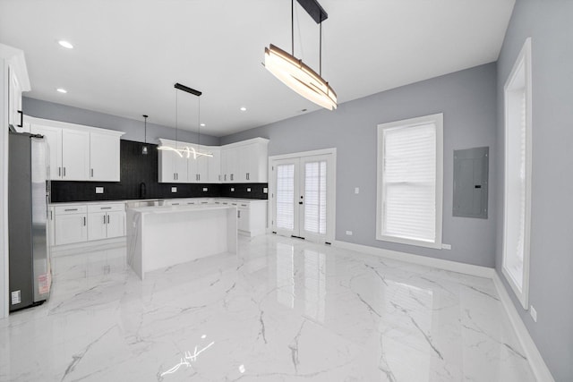 3628 S 54th Ct, Cicero, IL 60804 - kitchen with electric panel, freestanding refrigerator, light marble finish floors, a center island, and recessed lighting