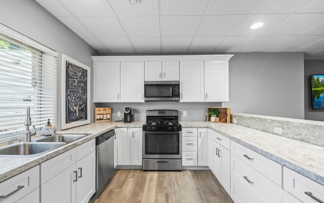 13052 Dunmoor Dr, Lemont, IL 60439 - kitchen featuring appliances with stainless steel finishes, light wood-type flooring, light countertops, white cabinets, and recessed lighting