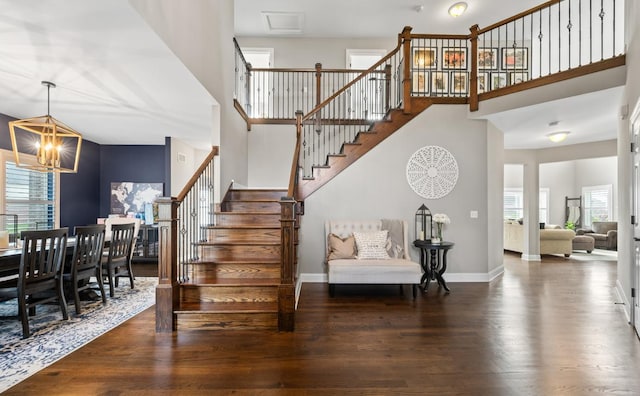 13052 Dunmoor Dr, Lemont, IL 60439 - staircase featuring a chandelier, a towering ceiling, healthy amount of natural light, and wood finished floors