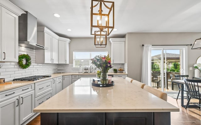 13052 Dunmoor Dr, Lemont, IL 60439 - kitchen featuring wall chimney exhaust hood, a center island, stainless steel gas stovetop, recessed lighting, and tasteful backsplash