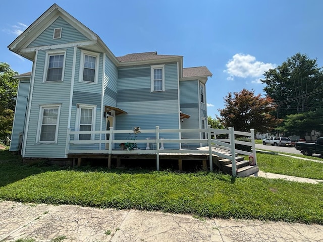 1844 Spruce St, Murphysboro, IL 62966 - view of front of home with a wooden deck, a front yard, and a shingled roof
