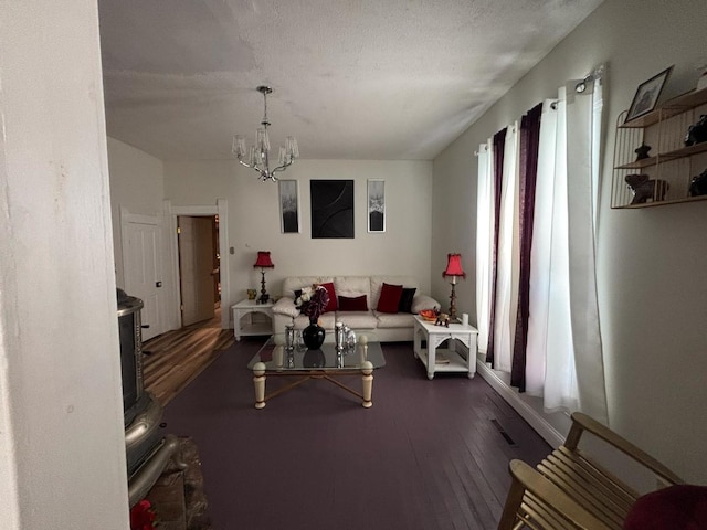 1844 Spruce St, Murphysboro, IL 62966 - living room with a chandelier, dark wood-style floors, a wood stove, and a textured ceiling