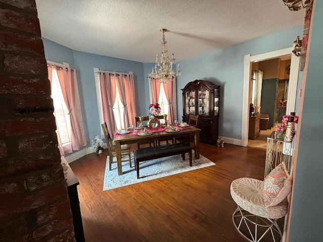 1844 Spruce St, Murphysboro, IL 62966 - dining space with a chandelier, wood finished floors, and a textured ceiling