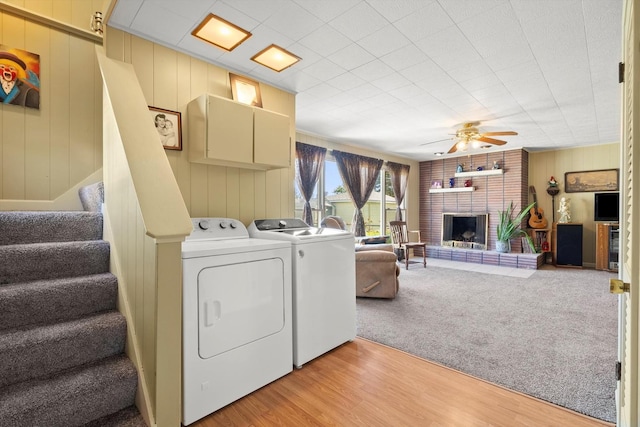 7306 W 115th St, Worth, IL 60482 - washroom featuring washing machine and clothes dryer, ceiling fan, light wood finished floors, and a fireplace