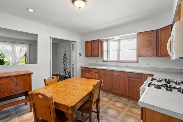 7306 W 115th St, Worth, IL 60482 - kitchen featuring white appliances, brown cabinets, healthy amount of natural light, and recessed lighting