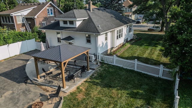 524 E 13th St, Lockport, IL 60441 - back of property with a gazebo, a patio area, a fenced backyard, and a chimney