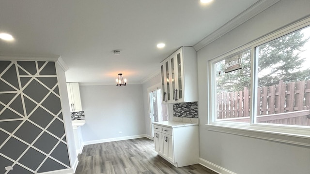 2100 Lloyd Ave, Lombard, IL 60148 - kitchen with decorative backsplash, white cabinetry, crown molding, wood finished floors, and recessed lighting