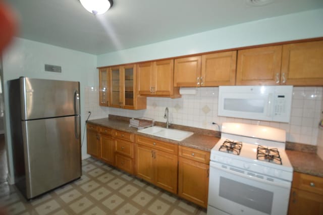 7921 Niles Ave, Skokie, IL 60077 - kitchen with white appliances, brown cabinets, and tasteful backsplash