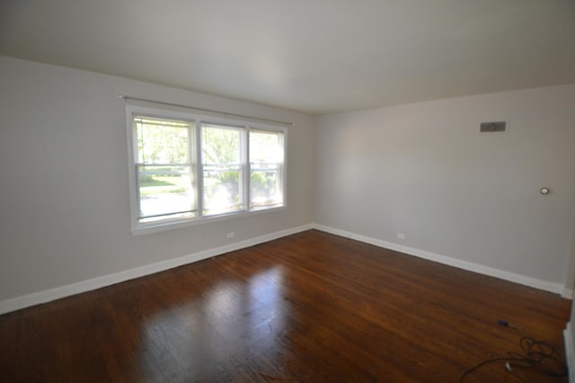 7921 Niles Ave, Skokie, IL 60077 - empty room with baseboards and dark wood-type flooring