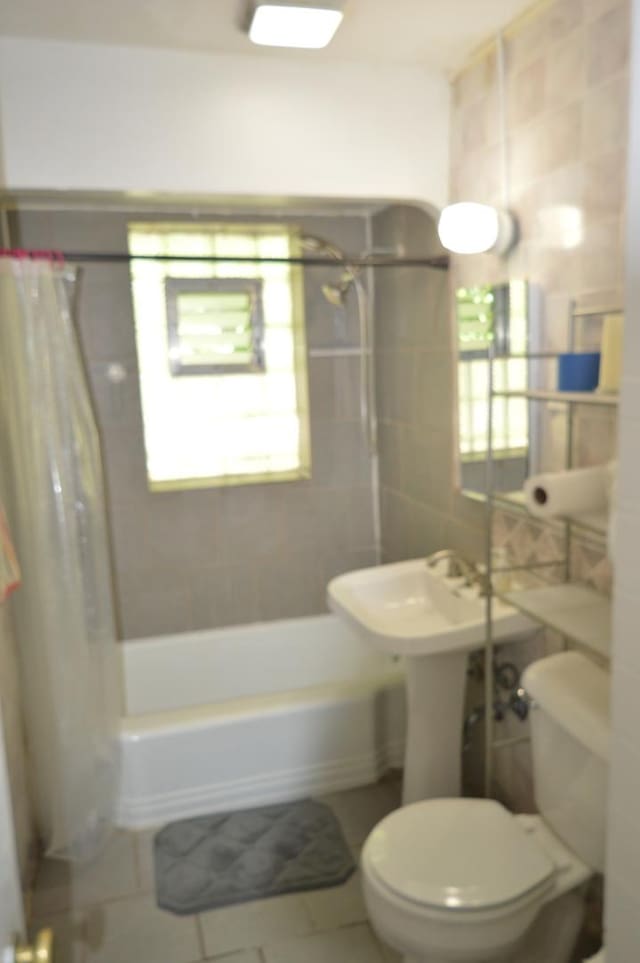 7921 Niles Ave, Skokie, IL 60077 - bathroom featuring shower / bathtub combination with curtain, tile patterned floors, and tile walls