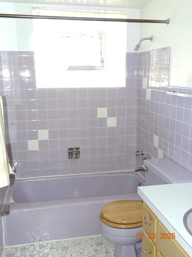 475 Courtesy Ln, Des Plaines, IL 60018 - bathroom featuring vanity, shower / bathtub combination, tile walls, and tile patterned flooring