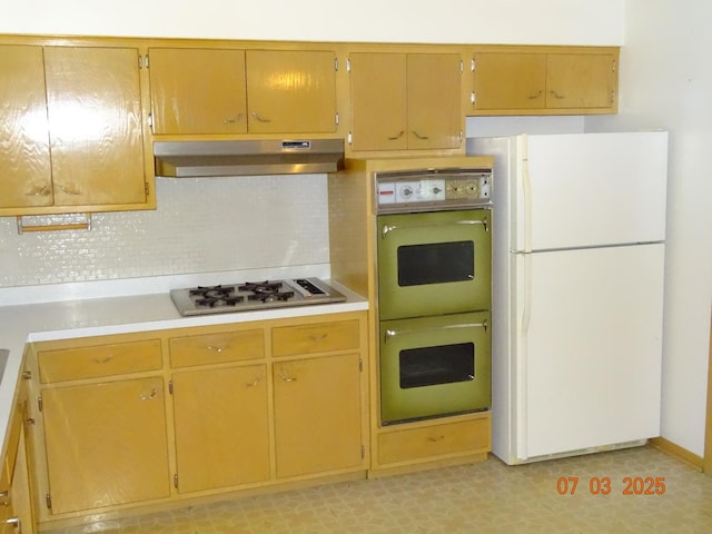 475 Courtesy Ln, Des Plaines, IL 60018 - kitchen with freestanding refrigerator, under cabinet range hood, double wall oven, gas stovetop, and light countertops