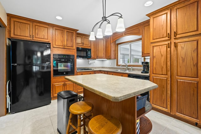 3717 W High St, Mchenry, IL 60050 - kitchen featuring black appliances, brown cabinets, light tile patterned floors, light countertops, and a center island