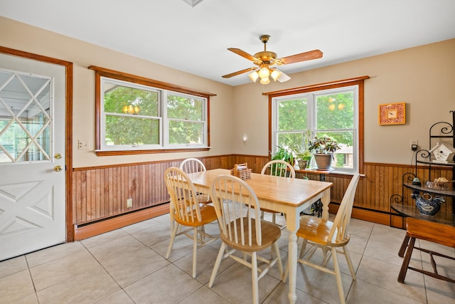 3717 W High St, Mchenry, IL 60050 - dining area with a wainscoted wall, wood walls, a baseboard radiator, light tile patterned floors, and a ceiling fan