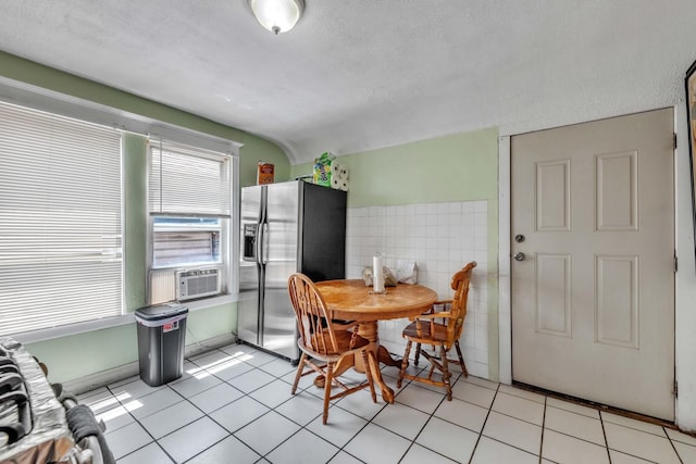 3031 S Central Park Ave, Chicago, IL 60623 - dining space with tile walls, a textured ceiling, light tile patterned floors, and cooling unit