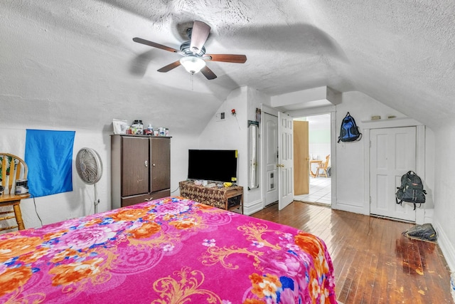 3031 S Central Park Ave, Chicago, IL 60623 - bedroom with a textured ceiling, hardwood / wood-style flooring, vaulted ceiling, and ceiling fan