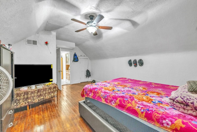 3031 S Central Park Ave, Chicago, IL 60623 - bedroom with a textured ceiling, hardwood / wood-style floors, vaulted ceiling, and a ceiling fan