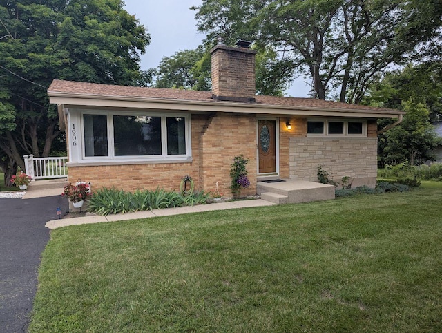 1906 Green Bay Rd, Zion, IL 60099 - ranch-style house featuring a chimney, a front yard, and stone siding