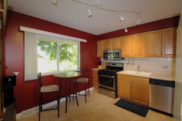1906 Green Bay Rd, Zion, IL 60099 - kitchen featuring stainless steel appliances, light countertops, and tasteful backsplash