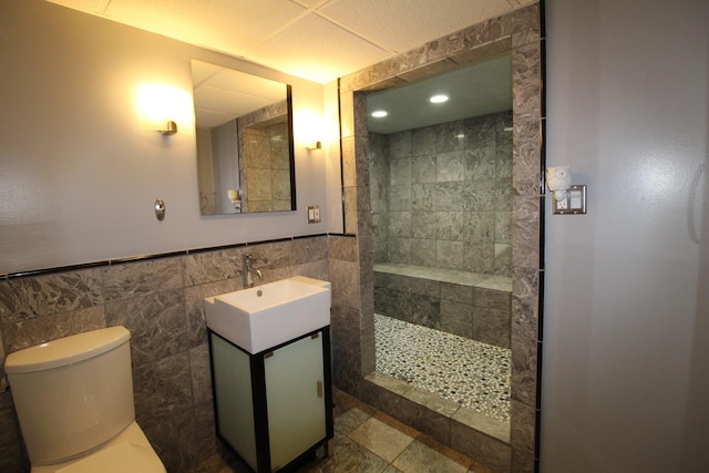 1906 Green Bay Rd, Zion, IL 60099 - bathroom featuring a walk in shower, vanity, tile walls, recessed lighting, and a wainscoted wall