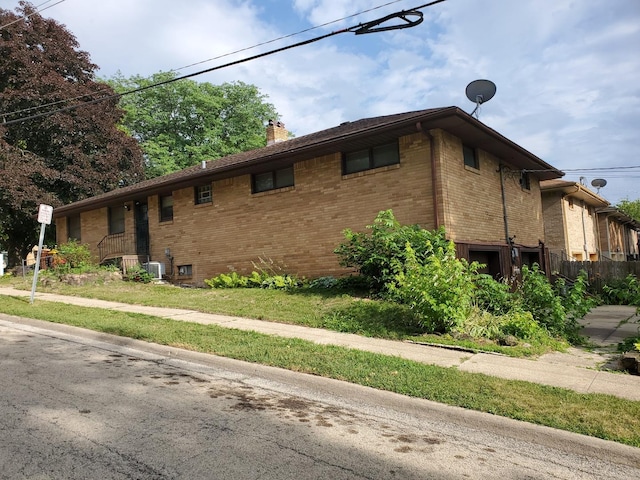 501 Fairview Ave, Rockford, IL 61108 - view of side of home featuring brick siding and a chimney