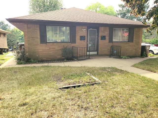 501 Fairview Ave, Rockford, IL 61108 - view of front of property with brick siding, a shingled roof, and a front lawn