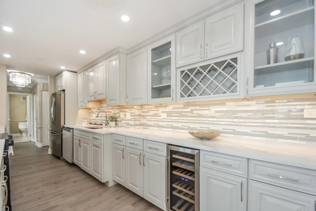111 E Chestnut St Unit 4400J, Chicago, IL 60611 - bar featuring beverage cooler, appliances with stainless steel finishes, backsplash, recessed lighting, and light wood finished floors