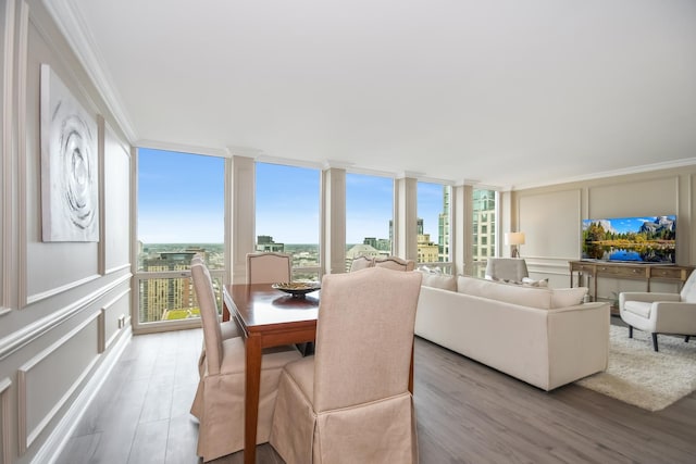 111 E Chestnut St Unit 4400J, Chicago, IL 60611 - dining area with crown molding, wood finished floors, floor to ceiling windows, and a decorative wall