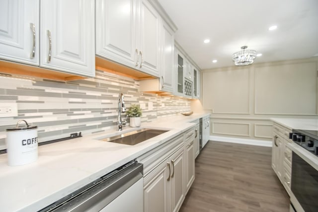 111 E Chestnut St Unit 4400J, Chicago, IL 60611 - kitchen with dishwasher, white cabinets, tasteful backsplash, stove, and dark wood-type flooring