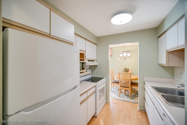 9716 S Karlov Ave S Unit 307, Oak Lawn, IL 60453 - kitchen with white appliances, light wood-type flooring, under cabinet range hood, white cabinets, and light countertops