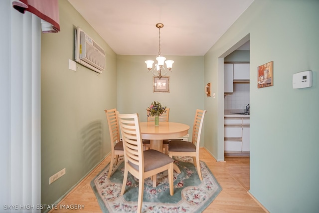 9716 S Karlov Ave S Unit 307, Oak Lawn, IL 60453 - dining area featuring a wall mounted AC, a chandelier, and light wood-style flooring