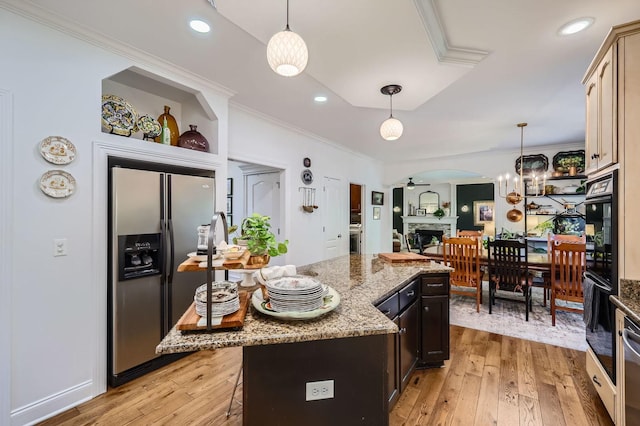 12740 Hawks Bill Ln, Plainfield, IL 60585 - kitchen with stainless steel fridge, ornamental molding, a fireplace, light wood-style floors, and light stone counters