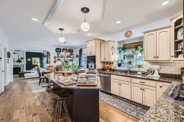 12740 Hawks Bill Ln, Plainfield, IL 60585 - kitchen with appliances with stainless steel finishes, ornamental molding, decorative backsplash, a kitchen bar, and arched walkways