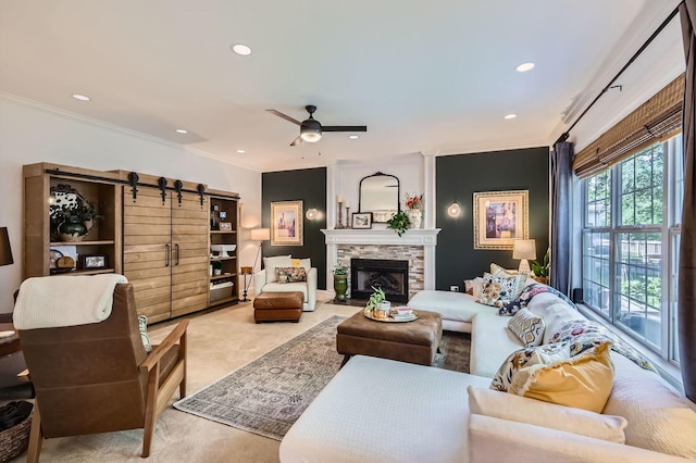 12740 Hawks Bill Ln, Plainfield, IL 60585 - carpeted living area featuring a barn door, crown molding, ceiling fan, recessed lighting, and a fireplace