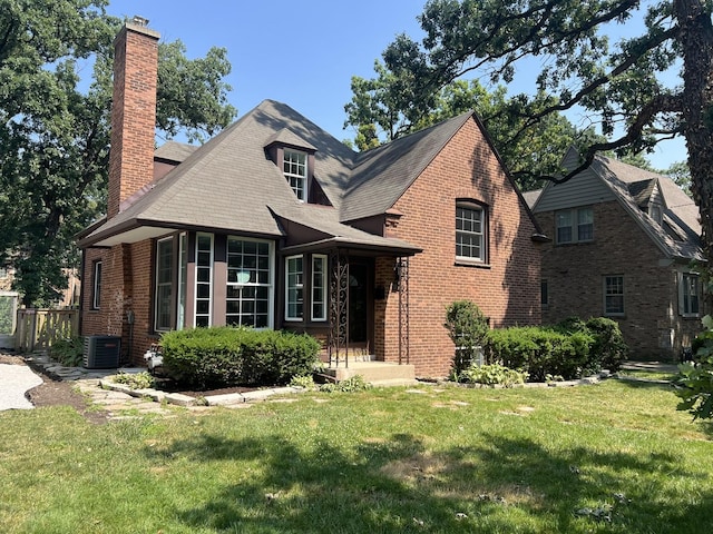 909 N Waiola Ave, La Grange Park, IL 60526 - view of front of house with a chimney, a front yard, and brick siding