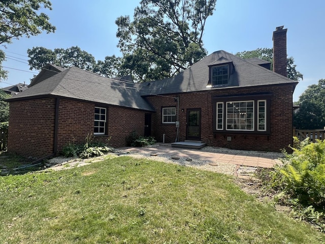 909 N Waiola Ave, La Grange Park, IL 60526 - back of house featuring a chimney, brick siding, and a lawn