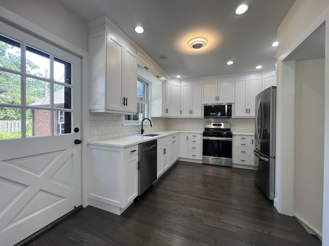 909 N Waiola Ave, La Grange Park, IL 60526 - kitchen featuring appliances with stainless steel finishes, plenty of natural light, backsplash, white cabinetry, and recessed lighting