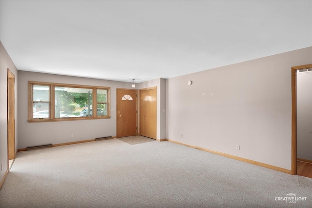 15418 S Pratt Ln, Plainfield, IL 60544 - carpeted empty room with baseboards and a baseboard heating unit