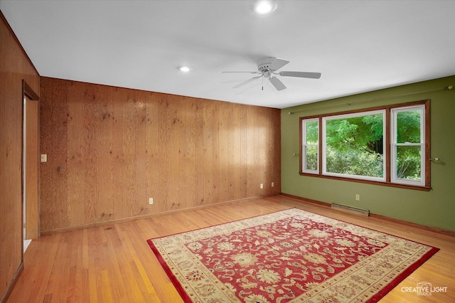 15418 S Pratt Ln, Plainfield, IL 60544 - unfurnished room with wooden walls, light wood-style flooring, ceiling fan, and recessed lighting