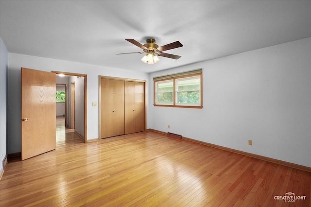 15418 S Pratt Ln, Plainfield, IL 60544 - unfurnished bedroom with multiple windows, a closet, light wood-style floors, and ceiling fan