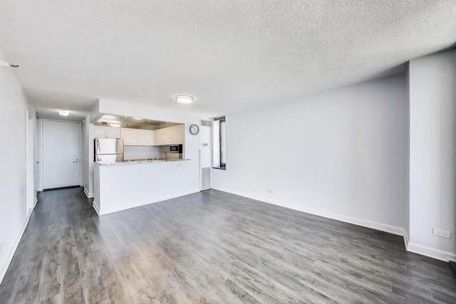 3660 N Lake Shore Dr Unit 3304, Chicago, IL 60613 - unfurnished living room featuring dark wood-type flooring and a textured ceiling