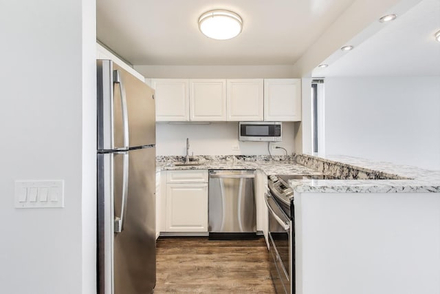 3660 N Lake Shore Dr Unit 3304, Chicago, IL 60613 - kitchen with stainless steel appliances, a peninsula, white cabinetry, and light stone counters