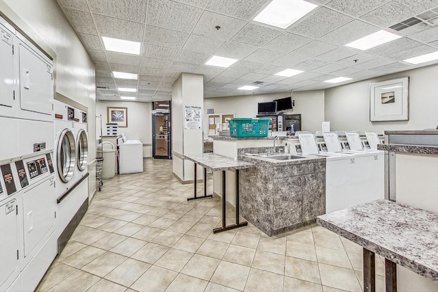 3660 N Lake Shore Dr Unit 3304, Chicago, IL 60613 - shared laundry with stacked washer / dryer, washer and dryer, and light tile patterned floors