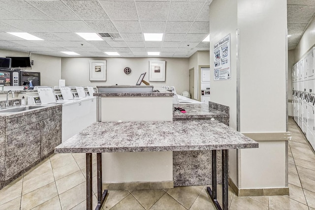 3660 N Lake Shore Dr Unit 3304, Chicago, IL 60613 - shared laundry with independent washer and dryer and light tile patterned floors