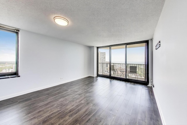 3660 N Lake Shore Dr Unit 3304, Chicago, IL 60613 - spare room featuring a textured ceiling, a wall of windows, healthy amount of natural light, and dark wood-style floors