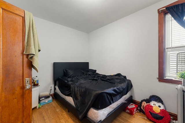 5121 W Henderson Ave, Chicago, IL 60641 - bedroom featuring light wood finished floors and radiator