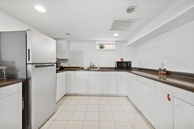 9519 Kolmar Ave, Skokie, IL 60076 - kitchen featuring freestanding refrigerator, dark countertops, white cabinetry, and recessed lighting