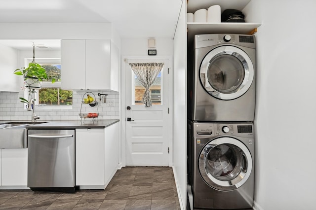 9519 Kolmar Ave, Skokie, IL 60076 - laundry room featuring stacked washer / dryer and a sink