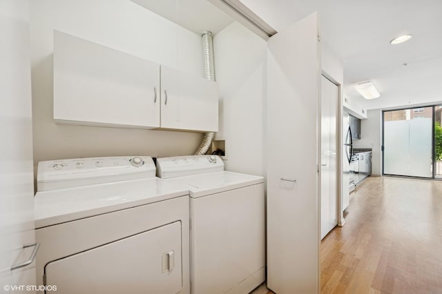 1740 Oak Ave Unit 103, Evanston, IL 60201 - laundry room featuring separate washer and dryer, cabinet space, light wood-style floors, and recessed lighting